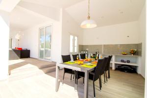 uma cozinha e sala de jantar com mesa e cadeiras em LEON INMO Villa Palmera - 10337 em Empuriabrava