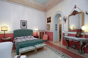 a bedroom with a bed and a mirror at B&B Flora House in Salerno