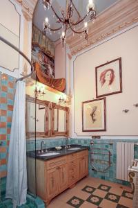 a bathroom with a sink and a chandelier at B&B Flora House in Salerno