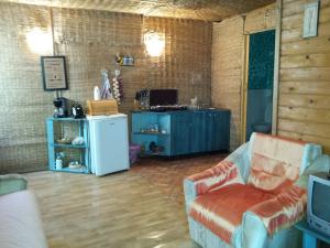a living room with a couch and a refrigerator at Casa Delta 106 in Sfântu Gheorghe