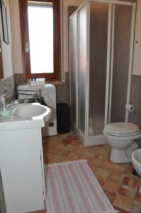 a bathroom with a toilet and a sink and a shower at Casa vacanza Nocellara in Menfi