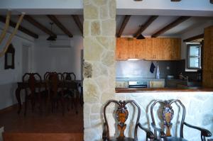 a kitchen and dining room with a table and chairs at Villa Kotronia in Afissos
