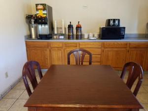 a wooden table and chairs in a kitchen at Knights Inn Franklin in Franklin