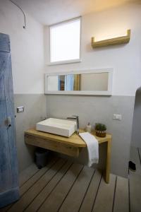a bathroom with a white sink and a mirror at Villa Mimi' in Nardò