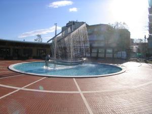 a person is standing in a fountain in a courtyard at Residence Darsena in Cattolica