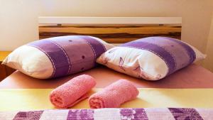 a group of three pillows on a bed at Apartman Dadić in Malinska +25 photos