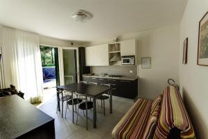 a kitchen with a table and a dining room at Villa Faro Vecchio in Cavallino-Treporti