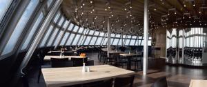 a dining room with tables and chairs and chandeliers at Hotel Ještěd in Liberec +37 photos