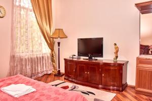 a living room with a flat screen tv on a cabinet at Hotel Art-Seg in Akhalk'alak'i