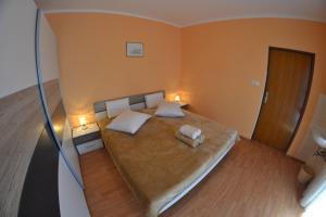 a bedroom with a large bed with two pillows at Apartman Jadranka in Rab