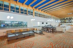 a large room with couches and a table and chairs at Red Lion Hotel Gillette in Gillette