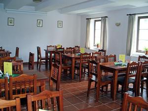 a dining room with wooden tables and chairs at Restaurace a Penzion Česká Hospoda in Heřmanice