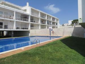 a hotel with a swimming pool in front of a building at Formosa Village in Fuzeta
