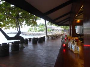 a table with bottles on it next to a beach at Club Santana Beach & Resort in Santana