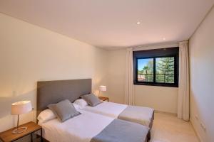 a bedroom with a large bed and a window at Mimosas Suites Banús in Marbella