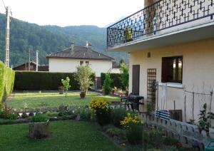 a house with a garden in front of it at Chez Laurette et Louis in Ugine