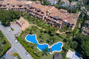 a large building with a lot of trees on top of it at Mimosas Suites Banús in Marbella