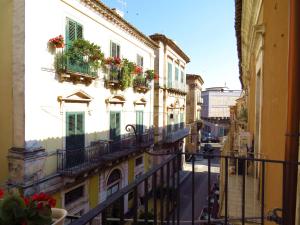 a view from a balcony of a building with flower boxes at L'arco delle Commari in Ragusa