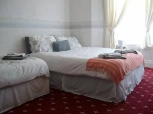 a bedroom with two beds with towels on them at Vista Sol in Blackpool
