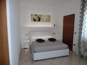 a bedroom with a bed with two pillows on it at Acquamarina B&B in Martinsicuro