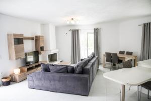 a living room with a couch and a table at Iridanos Apartments in Skiathos