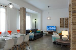 a living room with a table and a couch at TTdSSa VLC Purísima Street in Valencia