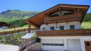 a house with a balcony on top of it at Apartment Wandspitz in Hintertux