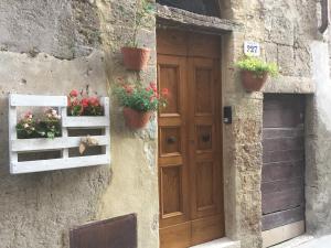 una puerta en un edificio de piedra con macetas. en Da Titta, en Pitigliano