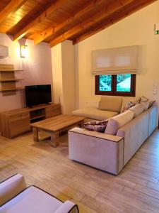 a living room with a couch and a table at Villa Dimitris in Parga