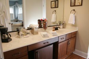 a bathroom with a sink and a large mirror at Seven Oaks Inn Bed and Breakfast in High Point