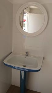 a bathroom with a sink and a mirror at Casa da Madrinha I in Monte Gordo