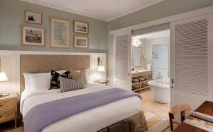 a hotel room with a bed and a desk at Strand Hotel Swakopmund in Swakopmund