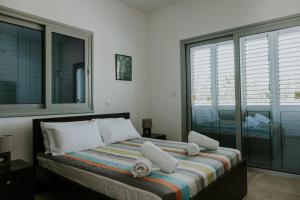 a bedroom with a bed with towels on it at Villa Despoina in Paphos City +72 photos