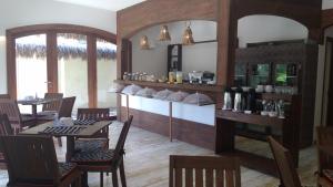 a restaurant with a table and chairs and a bar at Hotel Sao Francisco in Jericoacoara
