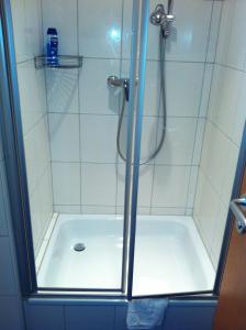 a shower with a glass door in a bathroom at Gasthaus Schützen in Hornberg