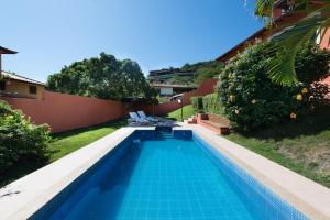 a swimming pool in the backyard of a house at Casa De Carlos in Búzios