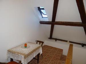 a dining room with a table and a window at Magdalena Apartman in Eger