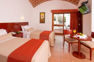 Postel nebo postele na pokoji v ubytování Hotel Las Dunas