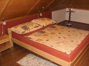 two beds in a room with a wooden floor at Privat Buk 100 in Jindřichŭv Hradec