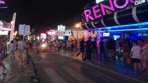 a crowd of people standing on a street at night at Beach Falésia in Albufeira +96 photos