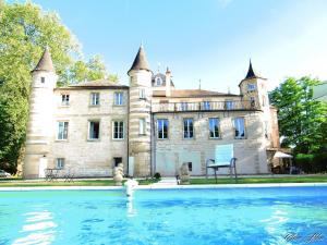 an old building with a pool in front of it at Chateau Du Four De Vaux in Varennes Vauzelles