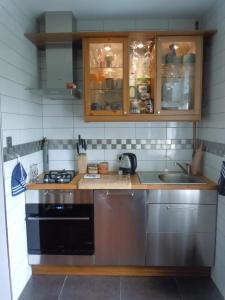 a kitchen with a stove and a sink at Apt nr 3 - cogito.home - Marina in Gdańsk
