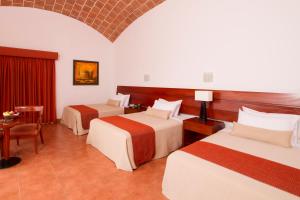 Postel nebo postele na pokoji v ubytování Hotel Las Dunas