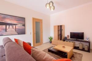 a living room with a couch and a tv at Skyline View in Lagos