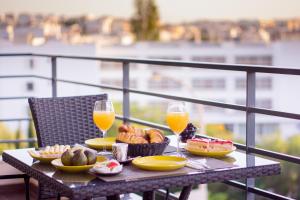 a table with food and wine glasses on a balcony at Skyline View in Lagos