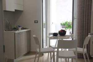 a kitchen and dining room with a table and chairs at Matera Guest House in Matera