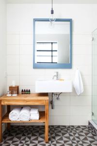 a bathroom with a sink and a mirror at Boro Hotel in Queens +30 photos