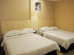 Krevet ili kreveti u jedinici u okviru objekta The Riverside Hotel Hengchun
