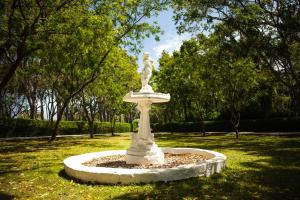 a statue sitting in the middle of a park at Colleton Great House in Saint Peter