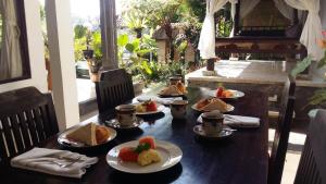 a table with a bunch of food on it at Pondok Anastasia in Ubud